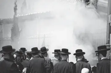  ?? CHEN JUNQING
Xinhua/Sipa USA ?? Ultra-Orthodox Jews burn leavened items Monday ahead of the Jewish Passover holiday in the Mea Shearim neighborho­od of Jerusalem.