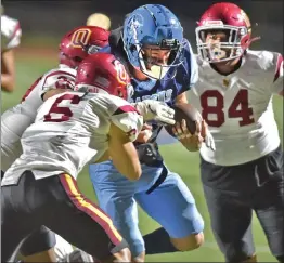  ?? Dan Watson/The Signal ?? Saugus running back Jacob Viger (10) powers his way towards the goal against Oxnard defenders at College of the Canyons on Friday. Saugus won, 35-12.