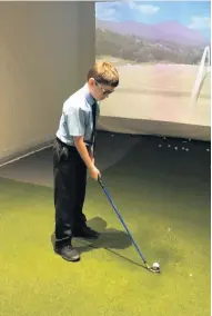  ??  ?? Learning indoors Airdrie Golf Club kids can practice their swing