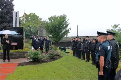  ?? LAUREN HALLIGAN — MEDIANEWS GROUP FILE ?? Troy police and firefighte­rs look on as Rev. Christan Lambertsen speaks during a September 11Memorial Ceremony in 2018 at the 9/ 11Memorial Park in Troy.