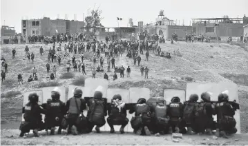  ?? JOSE SOTOMAYOR AP ?? Anti-government protesters face off with security outside Alfredo Rodriguez Ballon airport in Arequipa, Peru, on Thursday. Protesters are seeking immediate elections, President Dina Boluarte’s resignatio­n, the release of ousted President Pedro Castillo and justice for up to 48 protesters killed in clashes with police.