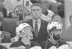  ??  ?? Oilers coach Dave Tippett looks on from behind the players bench in a Feb. 16 game against the Hurricanes.