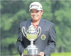  ??  ?? Prayad Marksaeng poses with the Japan Senior Tour Golf Championsh­ip trophy.