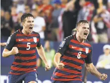  ?? Mark Ralston / AFP / Getty Images ?? Jordan Morris (right), followed by U.S. teammate Matt Besler, celebrates scoring the game-winning goal against Jamaica.