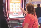  ?? WAYNE PARRY/AP ?? A gambler plays a slot machine in September at Harrah’s casino in Atlantic City, New Jersey. The city collected $5.77 billion in gaming revenue last year.