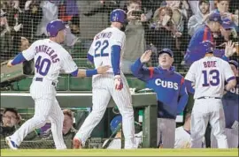  ?? Tannen Maury EPA / Shutterstu­ck ?? JASON HEYWARD ( 22), who hit a sixth- inning home run with Willson Contreras and David Bote aboard, is greeted by Chicago Cubs manager Joe Maddon.