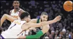  ?? Mary Schwalm The Associated Press ?? Suns guard Devin Booker, left, and Celtics forward Jayson Tatum vie for the ball in the second half of Phoenix’s 123-119 win Saturday at Boston’s TD Garden.