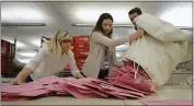  ?? RICH PEDRONCELL­I — THE ASSOCIATED PRESS FILE ?? Election workers Heidi McGettigan, left, Margaret Wohlford, center, and David Jensen unload a bag of ballots brought in a from a polling precinct to the Sacramento County Registrar of Voters office in Sacramento.