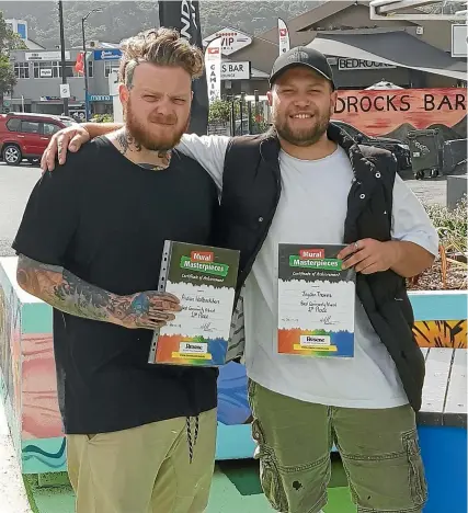  ??  ?? Aidan Walbaekken, left, and Jayden Thomas in the parklet they designed and created, which won them Best Community Mural in the Resene Mural Masterpiec­es competitio­n.