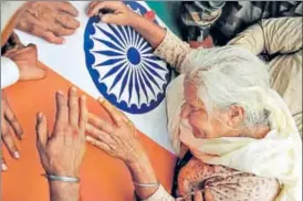  ?? PTI ?? Naib subedar Paramjit Singh's mother weeps over his coffin at their village Vain Poin, near Amritsar, on Tuesday. Singh, along with BSF’s Prem Sagar, was beheaded by Pakistan’s Border Action Team.