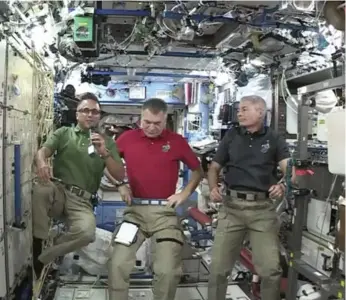  ?? NASA VIA THE ASSOCIATED PRESS ?? Joe Acaba, left, Paolo Nespoli, centre, and Mark Vande Hei. Nespoli was present for the first papal call in 2011.