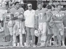  ?? STAFF PHOTO BY C.B. SCHMELTER ?? Tennessee quarterbac­ks Will McBride (17) and Jarrett Guarantano, left, stand with quarterbac­ks coach Mike Canales on the sideline during the Vols’ win over Southern Miss this month.