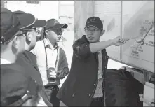  ?? PROVIDED TO CHINA DAILY ?? Chen Liang (right) instructs fellow academics in Beishan, Gansu province, in 2016.