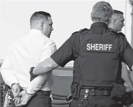  ?? GLEN WHIFFEN/THE TELEGRAM ?? Craig Pope looks at family members as he is escorted away in handcuffs following his sentencing Friday in Newfoundla­nd and Labrador Supreme Court.