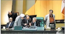  ?? SINA SHIRI/MEHR NEWS AGENCY ?? Members of Iran’s parliament, some of whom are shown, approved a bill Sunday that allows inspection­s of the country’s nuclear sites but prohibits access to military ones.