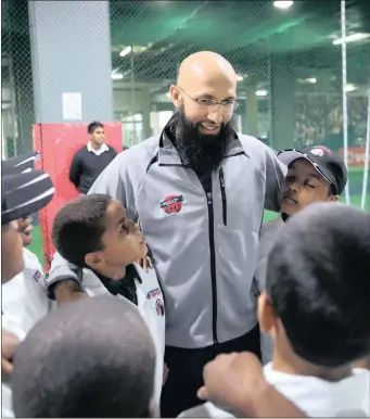  ??  ?? LEADING BY EXAMPLE: Hashim Amla with young cricketers at his cricket academy in Durban.