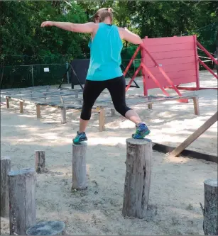  ?? Photo by Erica Moser ?? Deb Westgate-Silva walks across the balance logs.