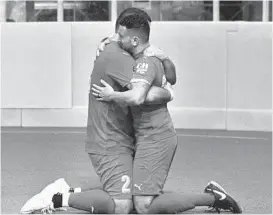  ?? KENNETH K. LAM/THE BALTIMORE SUN ?? The Blast’s Juan Pereira, right, embraces Vinny Dantas after beating the Savage (5-4) in pro indoor soccer playoff game at SECU Arena. Pereira said the moment was extra emotional because of the sudden death of his mother last week.