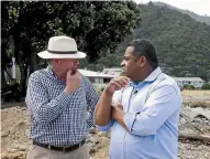  ??  ?? Minister of Civil Defence Kris Faafoi, right, and Coromandel MP Scott Simpson survey the damage on the Thames Coast Rd during a visit yesterday.