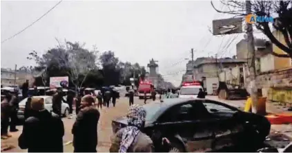  ?? - AFP ?? FLEEING TO SAFETY: An image grab taken from a video by Hawar News Agency (ANHA) shows people gathered at the scene of a suicide attack in the northern Syrian town of Manbij on January 16, 2019.