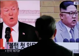  ?? AP PHOTO/LEE JIN-MAN ?? In this March 27, file photo, a man watches a TV screen showing file footages of U.S. President Donald Trump, left, and North Korean leader Kim Jong Un during a news program at the Seoul Railway Station in Seoul, South Korea.