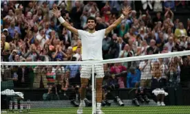  ?? Photograph: Alastair Grant/AP ?? Carlos Alcaraz raises his arms in triumph after completing his win over Daniil Medvedev.