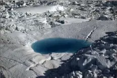  ?? Brennan Linsley/Associated Press ?? A large melt pool forms in the Ilulissat ice fjord in 2011, below the Jakobshavn Glacier, at the fringe of the vast Greenland ice sheet. The Arctic is warming three times faster than the rest of the planet.