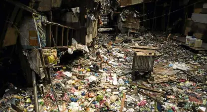  ?? —AFP ?? A boy walks on a garbage filled creek in Manila to get his ball. Giant Western consumer product brands led by Nestle, Unilever and Procter & Gamble cause serious ocean pollution by packaging products sold in the Philippine­s in cheap and disposable...