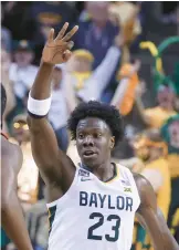  ?? ROD AYDELOTTE/AP ?? Baylor forward Jonathan Tchamwa Tchatchoua reacts to his three-pointer against Texas Tech during the second half of Saturday’s game in Waco, Texas.