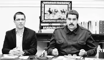  ??  ?? File photo shows Maduro (right) talking next to Venezuela’s vice-president Jorge Arreaza during a Council of Ministers meeting at Miraflores Palace in Caracas. — Reuters photo