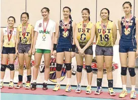  ??  ?? Ejiya Laure (third from right) displays her medal after winning the MVP honors and first best outside attacker plum while leading UST past National U for the Shakey’s Girls’ Volleyball League of Champions Season 14 crown at Ynares Sports Arena in Pasig...