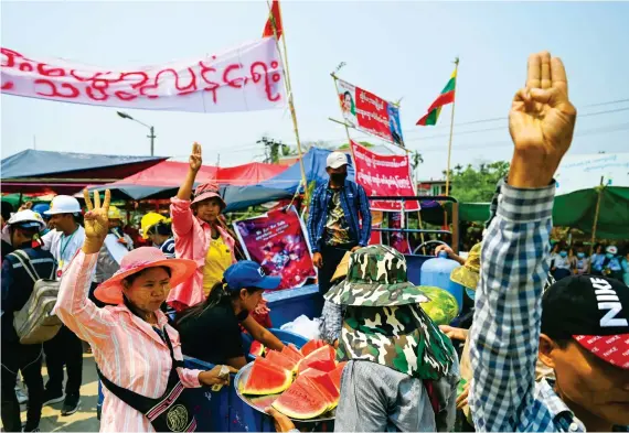  ?? AFP ?? Protesters gather in Yangon, main, as security forces continue to crack down on demonstrat­ions against the coup.