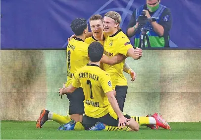  ?? Picture: Getty Images ?? GOAL GLUTTON. Borussia Dortmund’s Erling Haaland (right) celebrates with team-mates after scoring a goal in the first leg of their Champions League last-16 tie against Sevilla on Wednesday night.