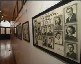  ?? ERIC BONZAR — THE MORNING JOURNAL ?? The main hallway of the former Brownhelm school is lined with pictures of graduating classes from throughout the school’s history.