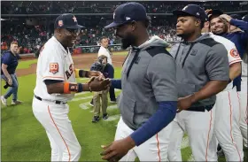  ?? DAVID J. PHILLIP - THE ASSOCIATED PRESS ?? Houston Astros’ Dusty Baker Jr., left, celebrates with players after a baseball game against the Seattle Mariners Tuesday, May 3, 2022, in Houston. The Astros won 4-0 giving Baker 2,000 career wins.
