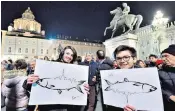  ??  ?? Supporters of the ‘Sardines’, an anti-populist Left-wing movement, hold the fish symbol of protest as they gather in Turin, Italy, during a Sardine Rally