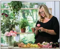  ?? The Washington Post/JENNIFER HEFFNER ?? Holly Chapple lays out and inspects each flower that goes into a bridal bouquet while working in her floral design studio in Loudoun County, Va.