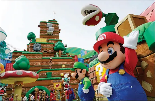  ?? PHOTOS BY CHRIS PIZZELLO / ASSOCIATED PRESS ?? The Nintendo video game characters “Mario,” right, and “Luigi” stand in the main plaza of the new Universal Studios Hollywood attraction Super Nintendo World during a preview day Feb. 16 in Universal City, Calif.