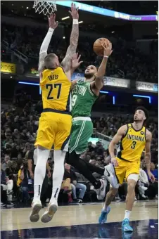  ?? AP PHOTO/AJ MAST ?? Boston Celtics guard Derrick White (9) shoots against Indiana Pacers center Daniel Theis (27) during the first half of an NBA basketball game in Indianapol­is, Thursday, Feb. 23, 2023.