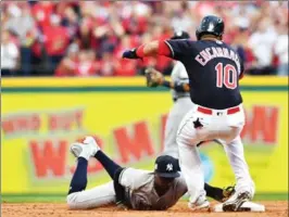  ?? JASON MILLER, GETTY IMAGES ?? Cleveland’s Edwin Encarnacio­n rolls his ankle in the first inning of Game 2.