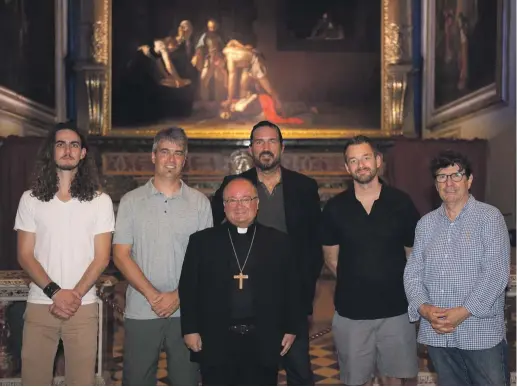  ??  ?? Archbishop Charles Scicluna with Jim Caviezel, back centre, and ‘Paul, Apostle of Christ’ crew members at St John's Co-Cathedral, with Caravaggio’s The Beheading of Saint John the Baptist as a backdrop