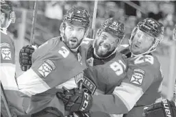  ?? LYNNE SLADKY/AP ?? Panthers defenseman Keith Yandle (3) celebrates with left wing Anthony Duclair (91) and center Carter Verhaeghe (23) after scoring a goal during the second period against the Dallas Stars on Monday in Sunrise.