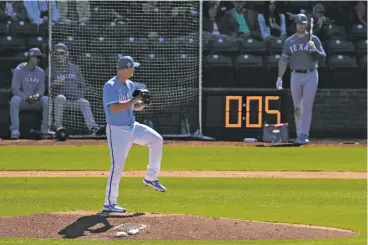  ?? CHARLIE RIEDEL/THE ASSOCIATED PRESS ?? Kansas City’s Nick Wittgren throws before a pitch clock expires during a Friday spring training game against Texas in Surprise, Ariz. Several pitchers have said one effect of the new clock has been that they are getting tired on the mound.