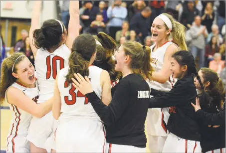  ?? Dave Phillips / For Hearst Connecticu­t Media ?? Members of the Cromwell girls basketball team celebrate their win over Coginchaug in the Shoreline Conference championsh­ip game.