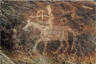  ??  ?? An ancient engraving of a hunter is seen in the hills outside the town of Khomein in central Iran.