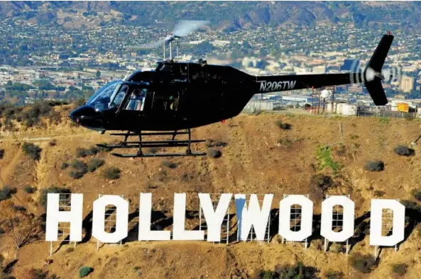  ?? GROUP 3 AVIATION ?? A helicopter from Group 3 Aviation takes visitors over Los Angeles’s world- famous Hollywood sign.