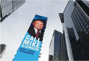  ?? (Andrew Kelly/Reuters) ?? A BILLBOARD for Democratic candidate and former New York City mayor Mike Bloomberg is seen in Times Square in New York City on Monday.