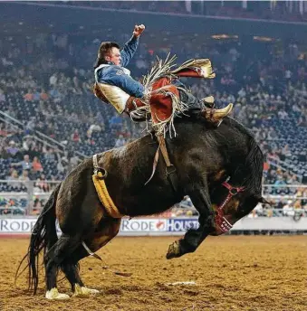  ?? Karen Warren / Houston Chronicle ?? Richie Champion shows his form in the Houston Rodeo’s Super Series III championsh­ip bareback riding event on Wednesday, when he tied for first place and earned a spot in this week’s semifinals.