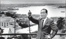  ?? / AP ?? Mitsuo Fuchida, 64, the man who led the surprise attack on Pearl Harbor recalls the events of Dec. 7, 1941 on his return visit to Hawaii 25 years later in 1966. Fuchida, his back to Pearl Harbor, points to where he led the Japanese planes through the mountains of Oahu Island and down on the the crowed Harbor where several warships rode at anchor.