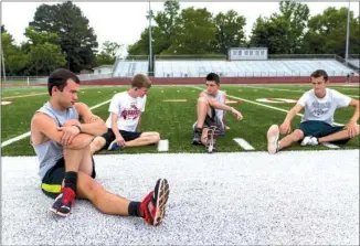  ?? GARETH PATTERSON/THREE RIVERS EDITION ?? Malachi Cannon, from left, Jon Ogle, Steven Childress and Christian Dawkins stretch on the Heber Springs High School football field before a track practice. The boys are part of the Panthers track team that won the unofficial Arkansas boys high school...